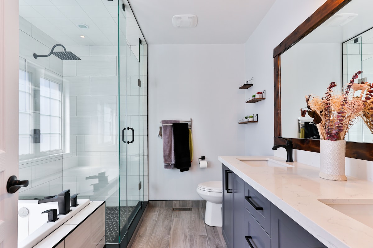A finished modern bathroom with a walk-in shower and vanity unit