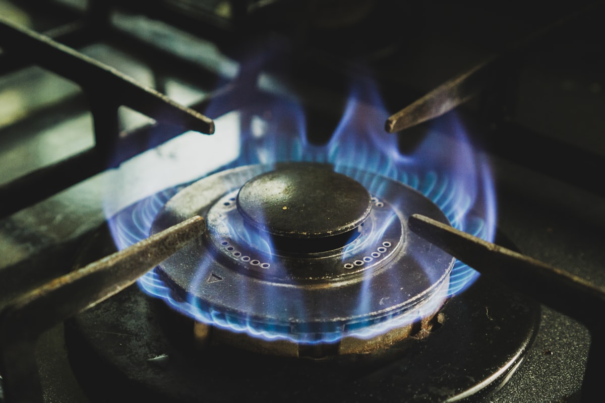 A gas hob flame being checked during a safety inspection